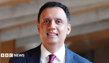 Anas Sarwar wears a dark suit and has short dark hair