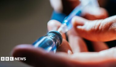 A close up of a person's hands as they prepare an injection