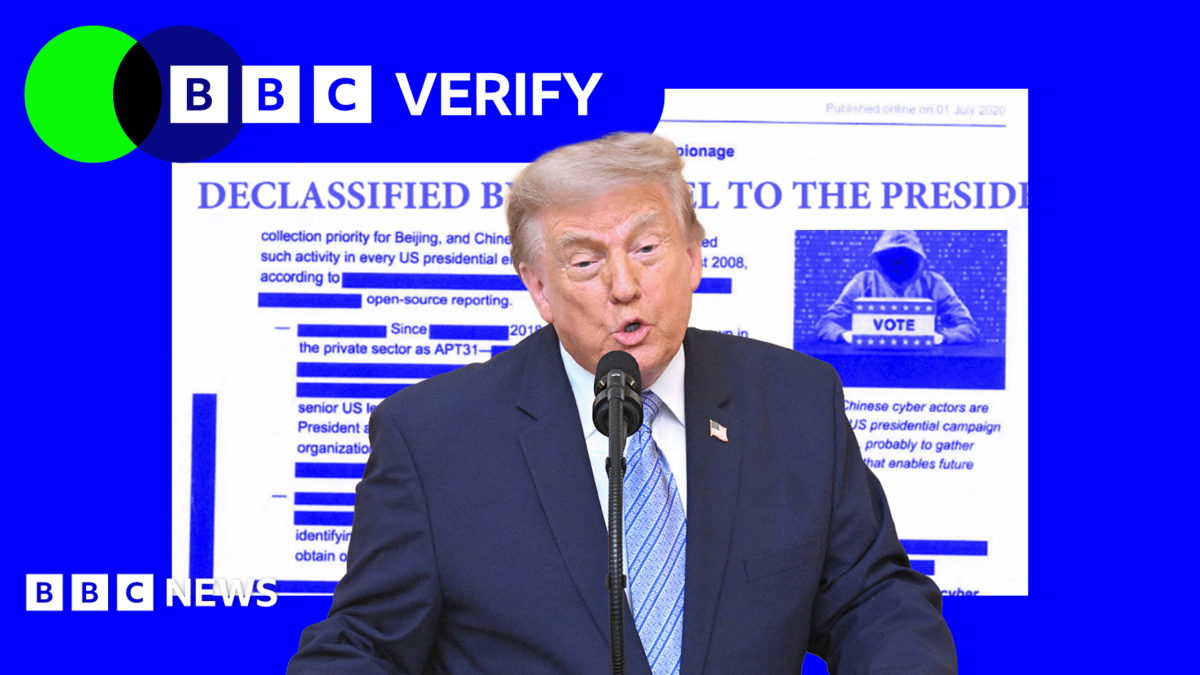President Trump speaking in front of a microphone with a graphic showing a declassified document behind him.