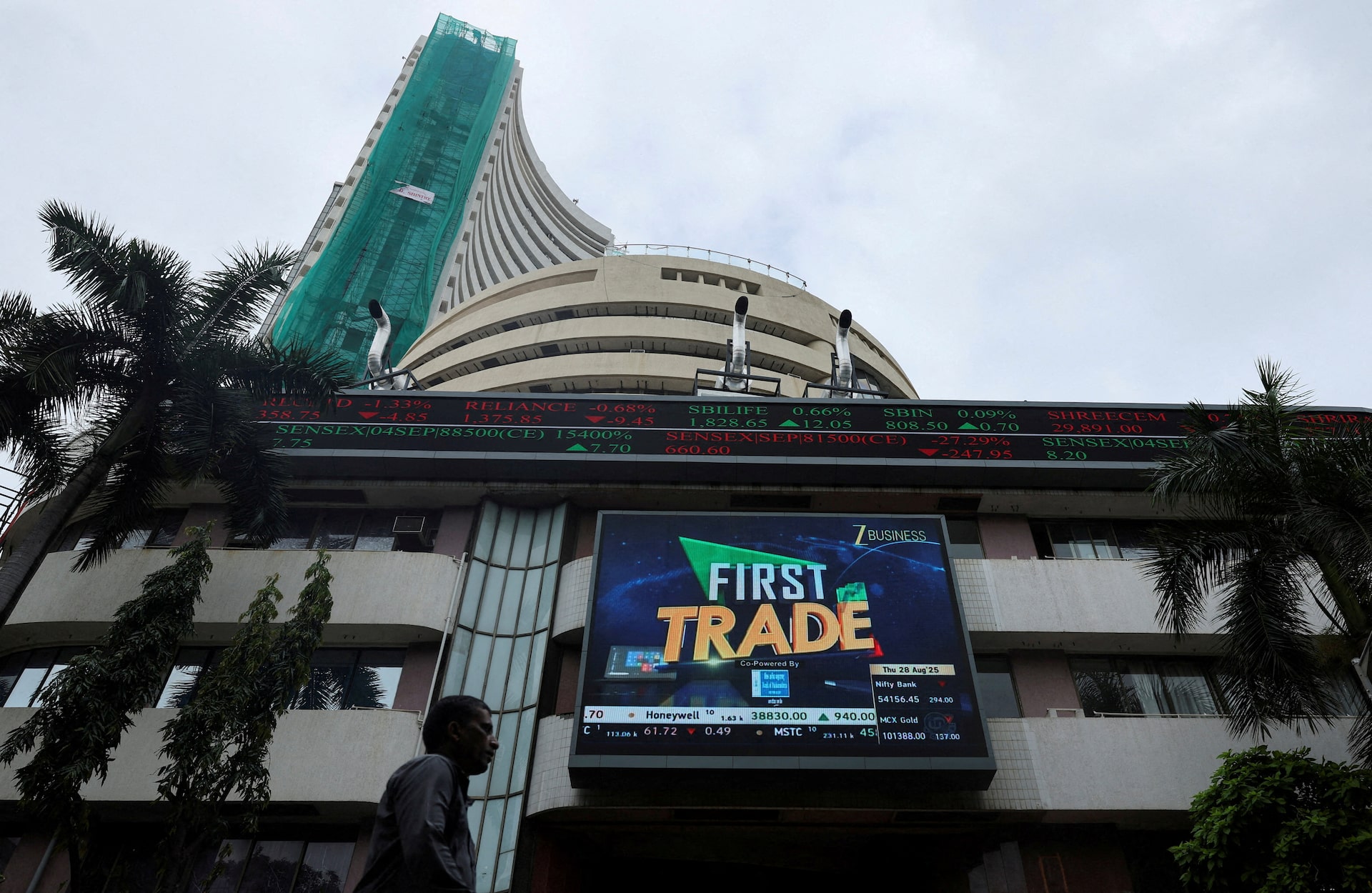 A man walks near a screen outside the Bombay Stock Exchange (BSE) in Mumbai