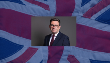 Andy Burnham with a fabric UK flag behind him