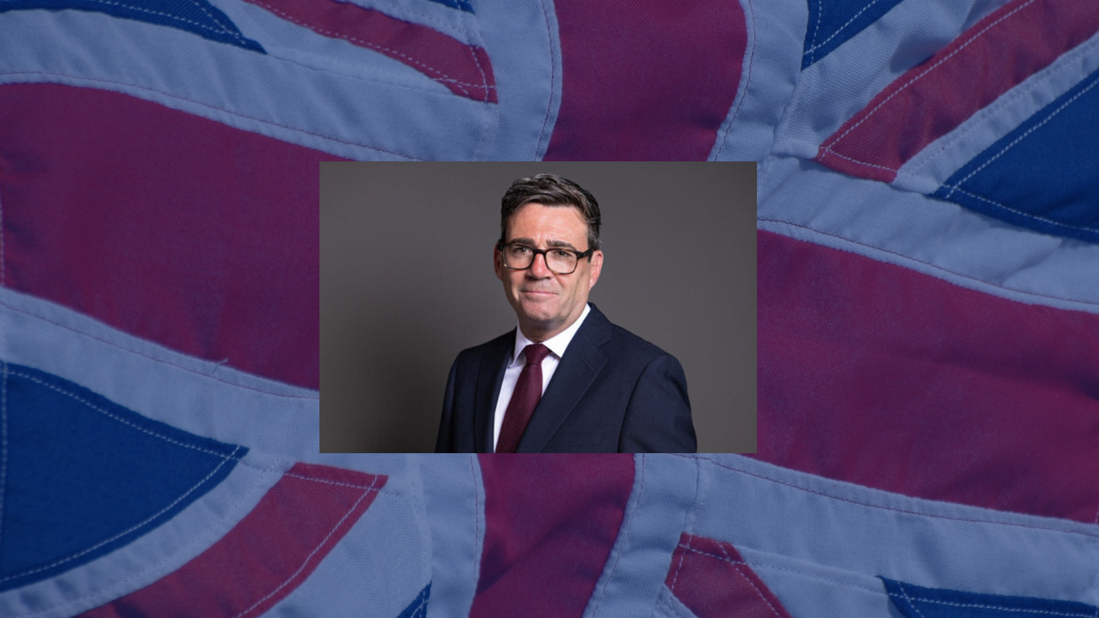 Andy Burnham with a fabric UK flag behind him