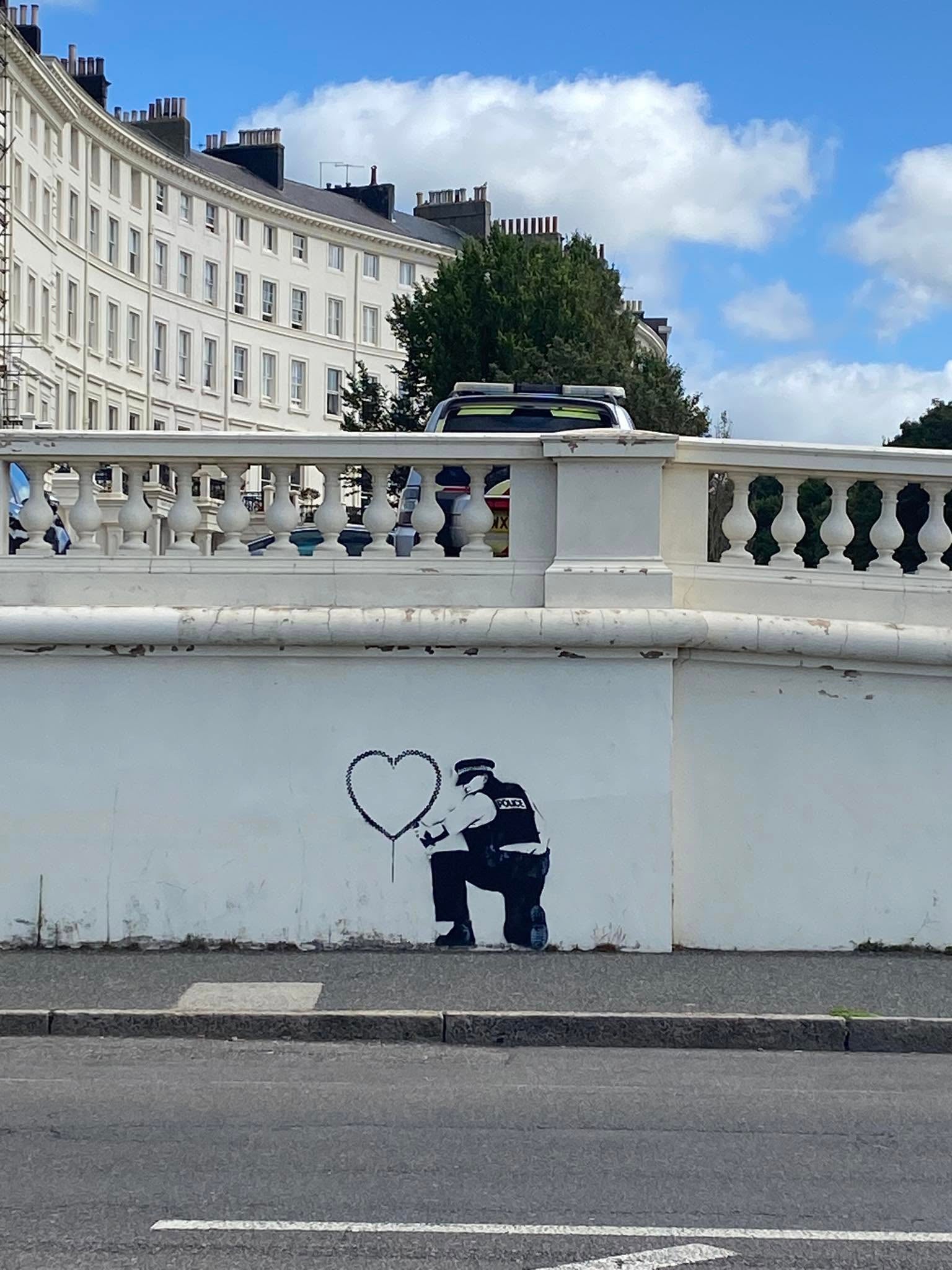 A police car can be seen near the alleged Banksy mural on the Hove seafront on Wednesday