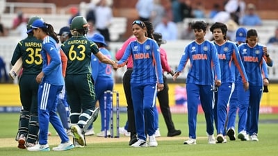 India's captain Harmanpreet Kaur (C) shakes hands with Australia's Ashleigh Gardner after Australia's victory in the Women's T20 world cup game (AFP)