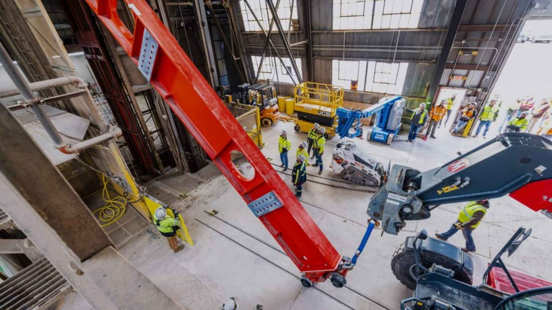 A 43-foot steel beam weighing 15,890 pounds rides 4,850 feet down an old South Dakota gold mine standing upright in a cage 4.5 feet wide, one of roughly 2,100 pieces that have to make the same trip before summer ends