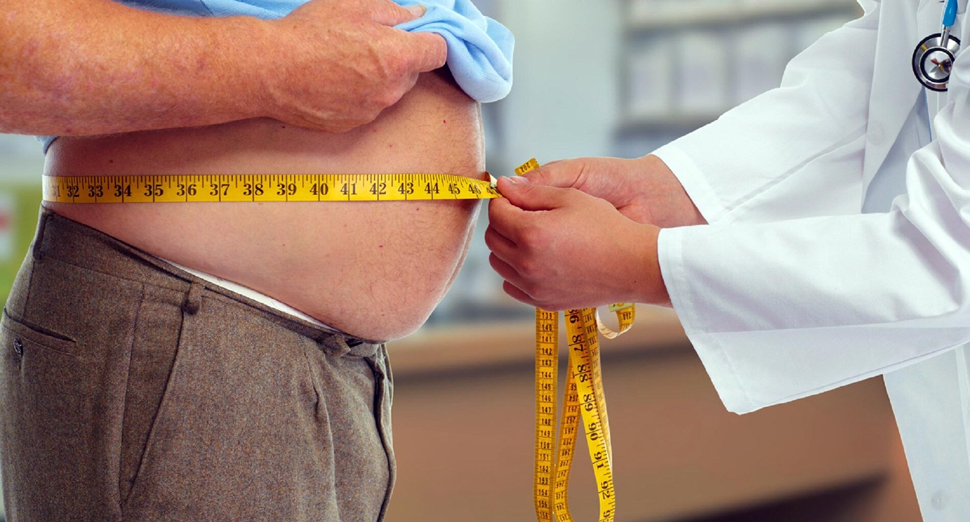 Doctor Measuring Waist Obese Man