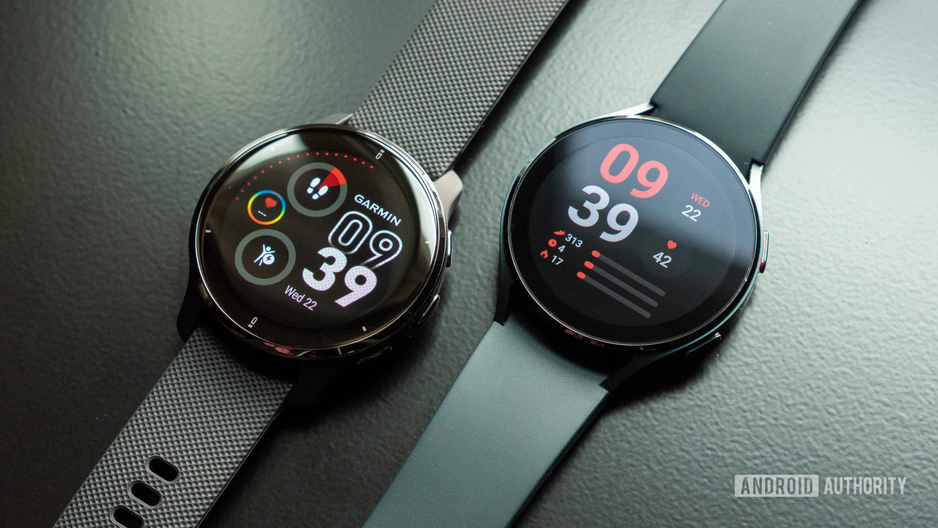 Garmin Venu 2 Plus review vs Samsung Galaxy Watch 4 An image of the Garmin Venu 2 Plus on a table vs the Samsung Galaxy Watch 4
