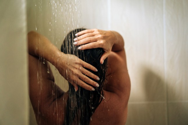 Woman in the hotel room having a shower