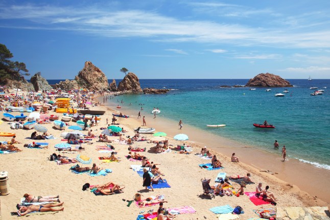 Crowded beach in Spain at Mediterranean Sea
