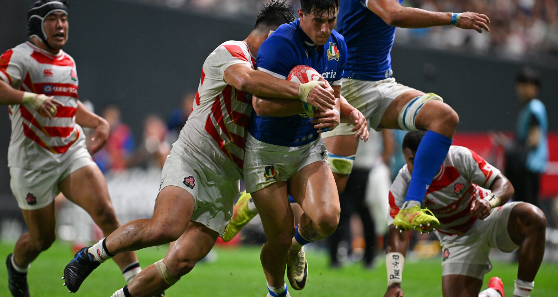 Tommaso Menoncello of Italy is tackled by Shuhei Takeuchi of Japan during the July 2024 international