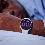 Smartwatch Doing EKG Cardiogram On Man's Wrist During Sleep - stock photo