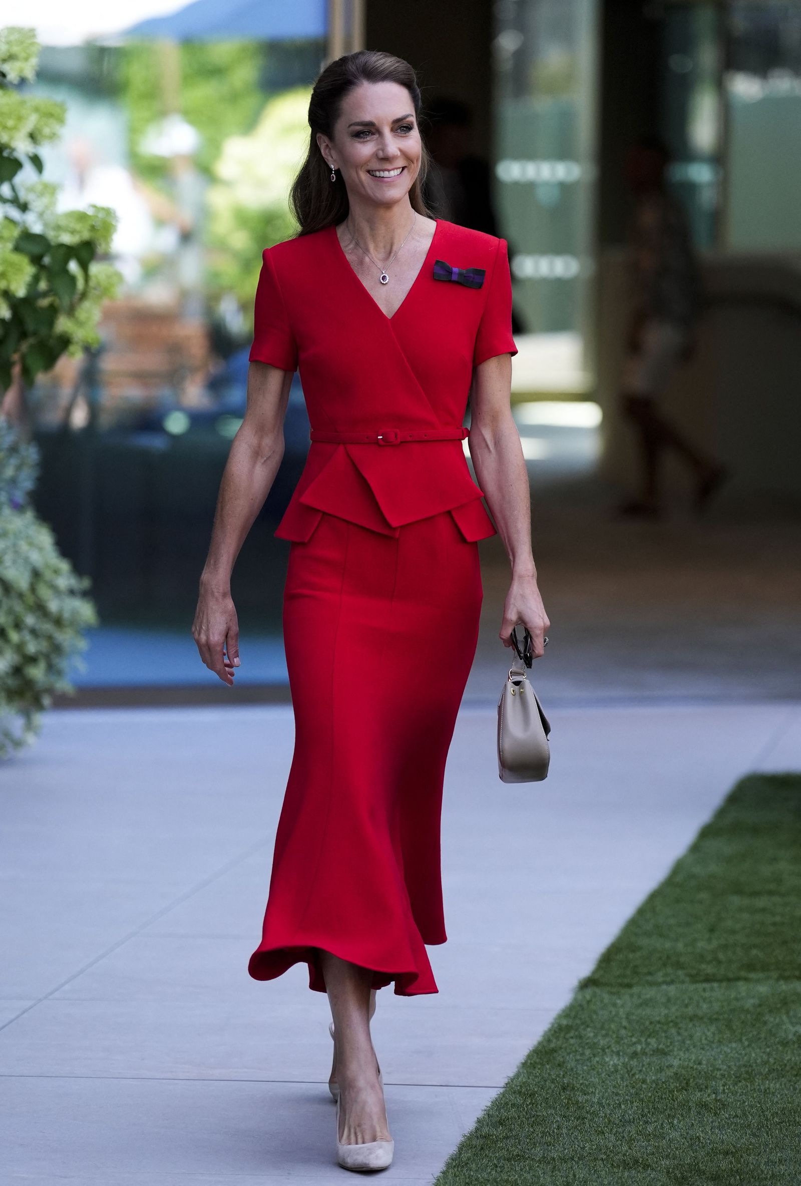 Image may contain Person Adult Formal Wear Clothing Dress Suit Skirt Accessories Bag and Handbag