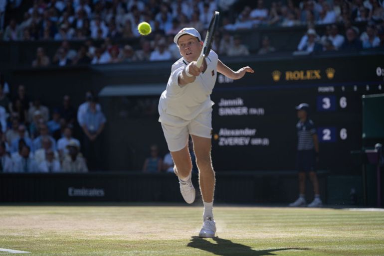 Jannik Sinner of Italy plays a backhand against Alexander Zverev of Germany during their Gentlemen's Singles final match on day fourteen of The Championships Wimbledon 2026 at All England Lawn Tennis and Croquet Club