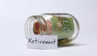 A glass jar resting on its side with Canadian banknotes and change inside.