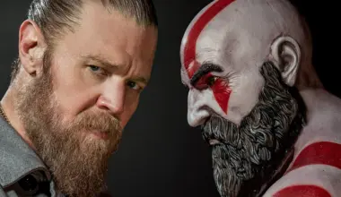 Actor Ryan Hurst stands opposite a Kratos statue for God of War.