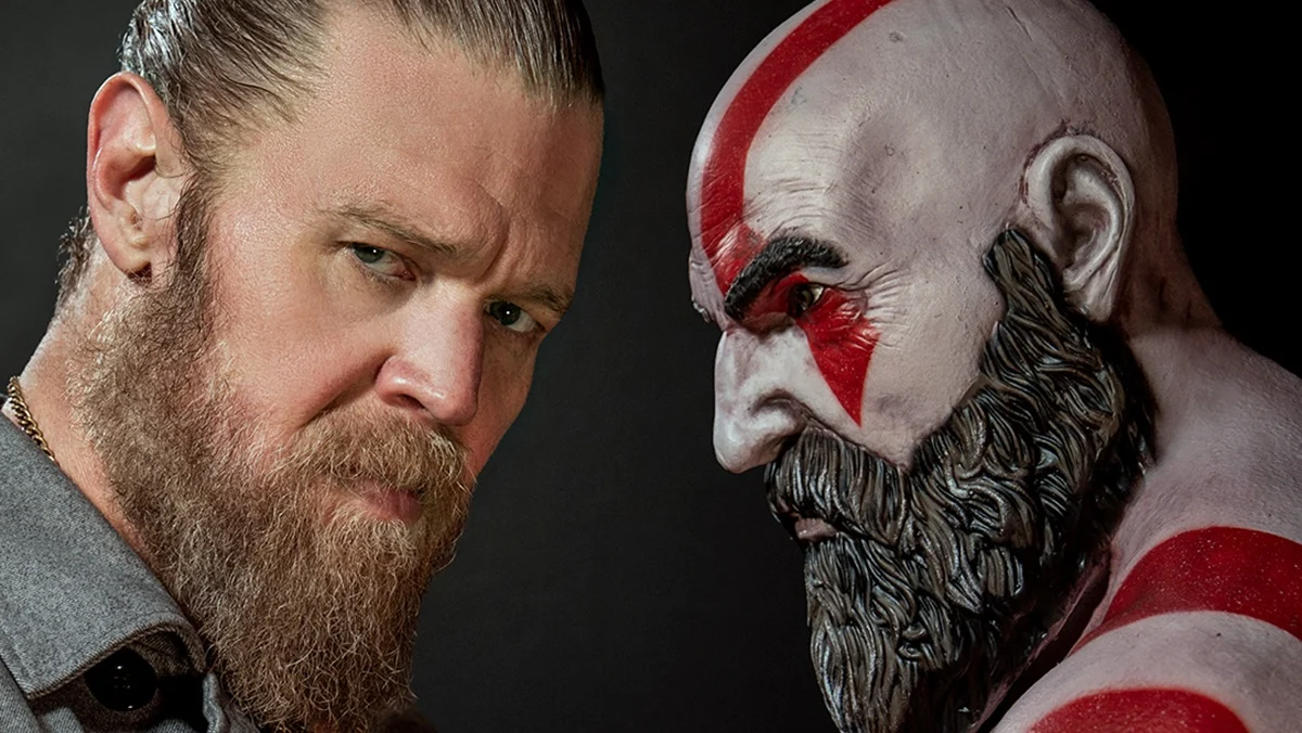 Actor Ryan Hurst stands opposite a Kratos statue for God of War.