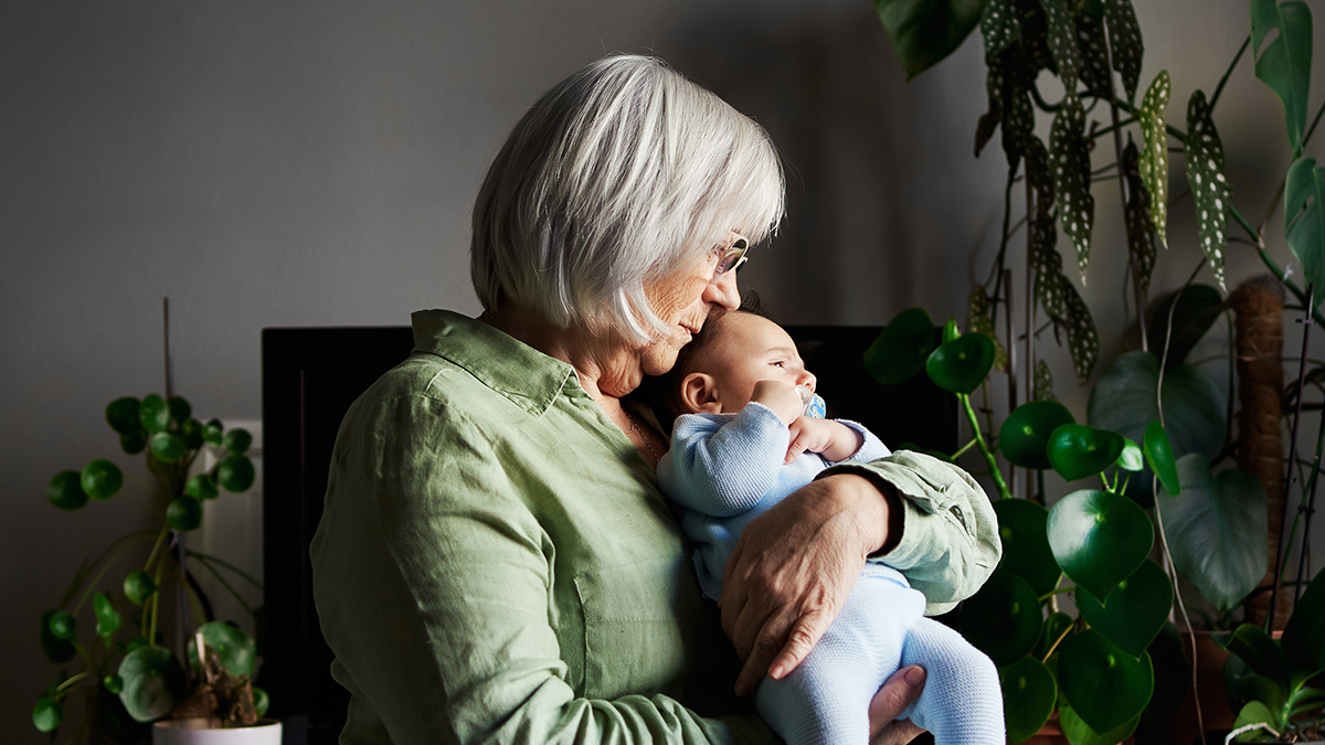 An elderly lady with a baby