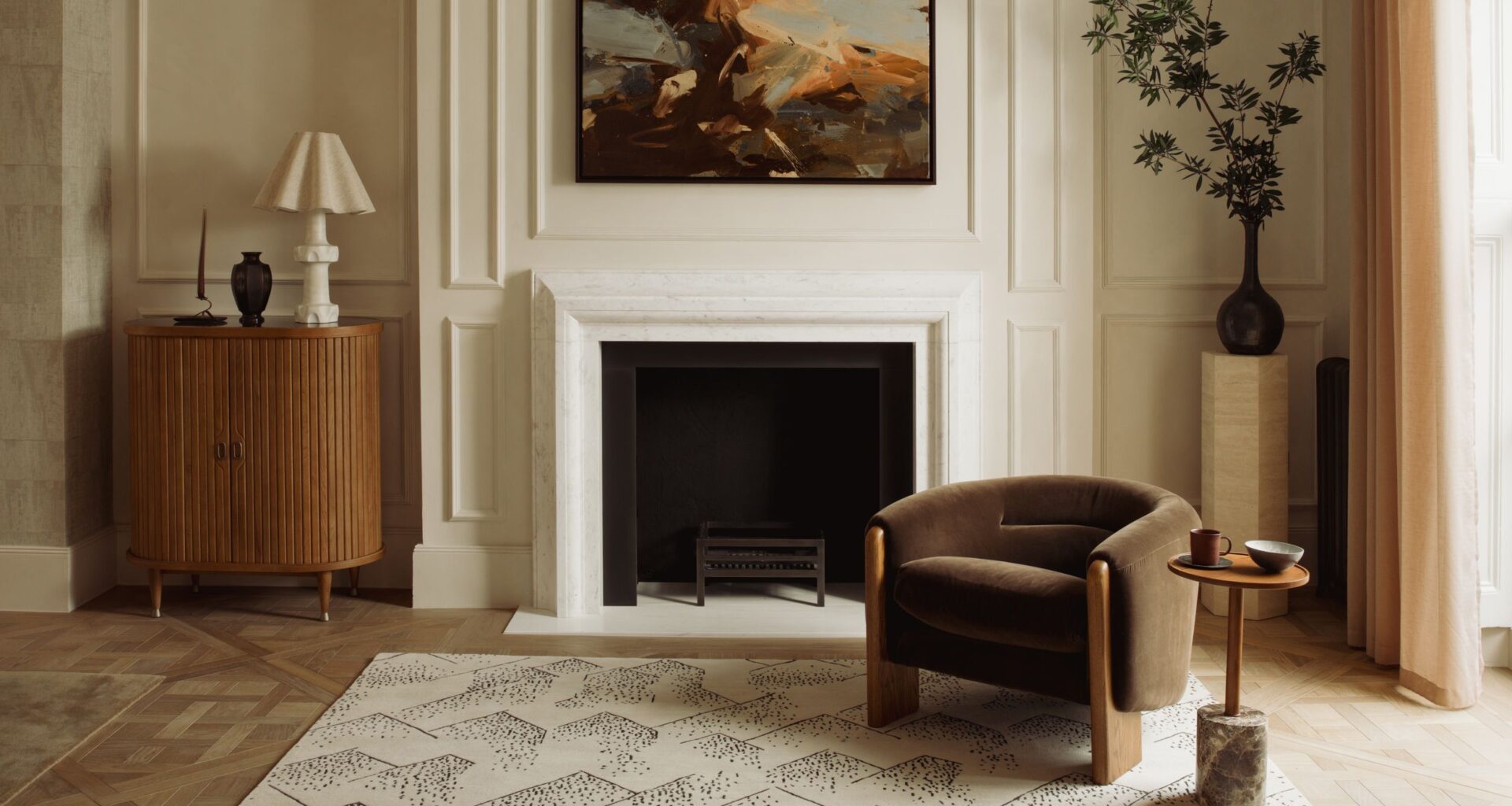 neutral living room with fireplace and brown armchair