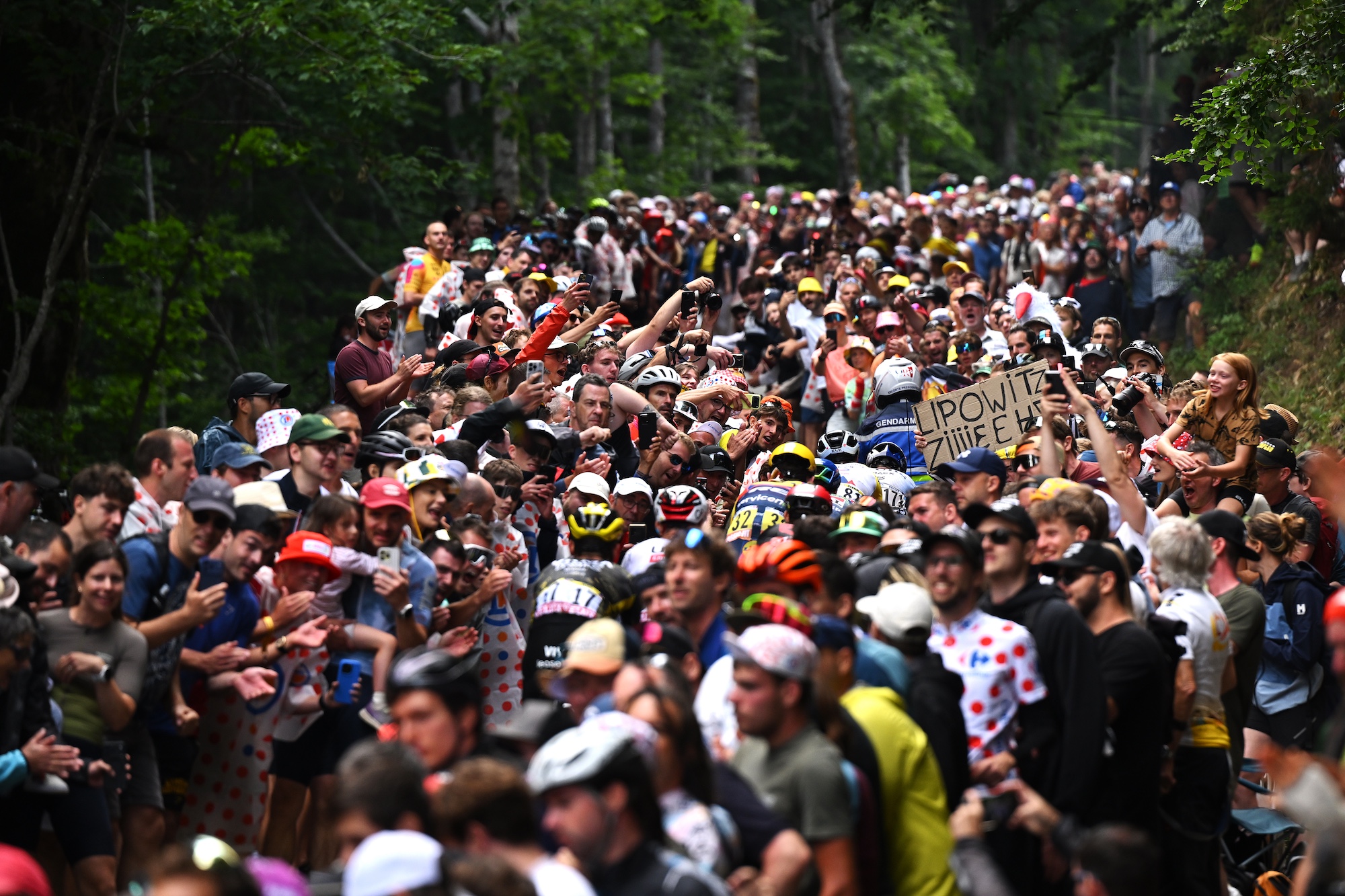 A general view of Tom Pidcock of Great Britain and Team Pinarello Q36.5 Pro Cycling, Egan Bernal of Colombia and Netcompany INEOS Cycling Team, Derek Gee-West of Canada and Team Lidl - Trek climbing to the Col du Haag (1225m) while fans cheers during stage 14 of the Tour de France (Photo by Dario Belingheri/Getty Images)