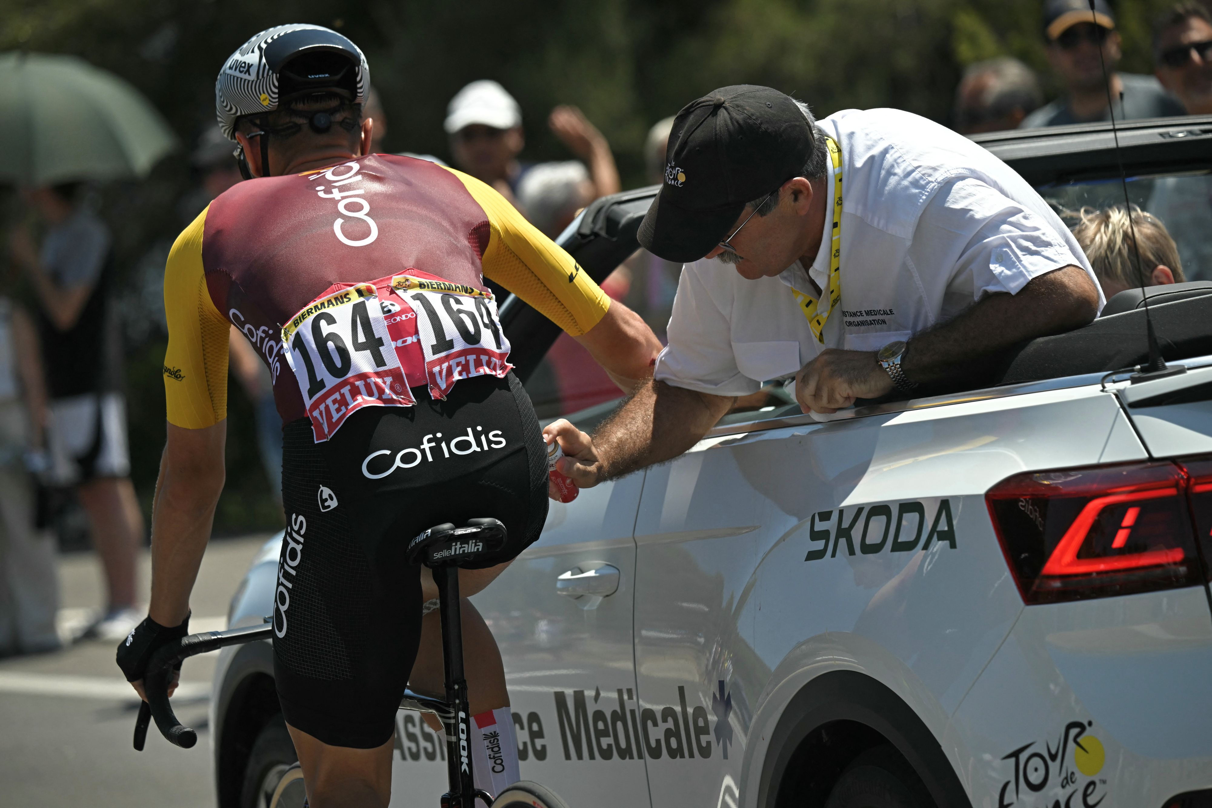 Cofidis team's Belgian rider Jenthe Biermans receives medical attention as he cycles during the 2nd stage of the 113th edition of the Tour de France cycling race, 168,5 km between Tarragona and Barcelona in northeastern Spain, on July 5, 2026. (Photo by Loic VENANCE / AFP via Getty Images)