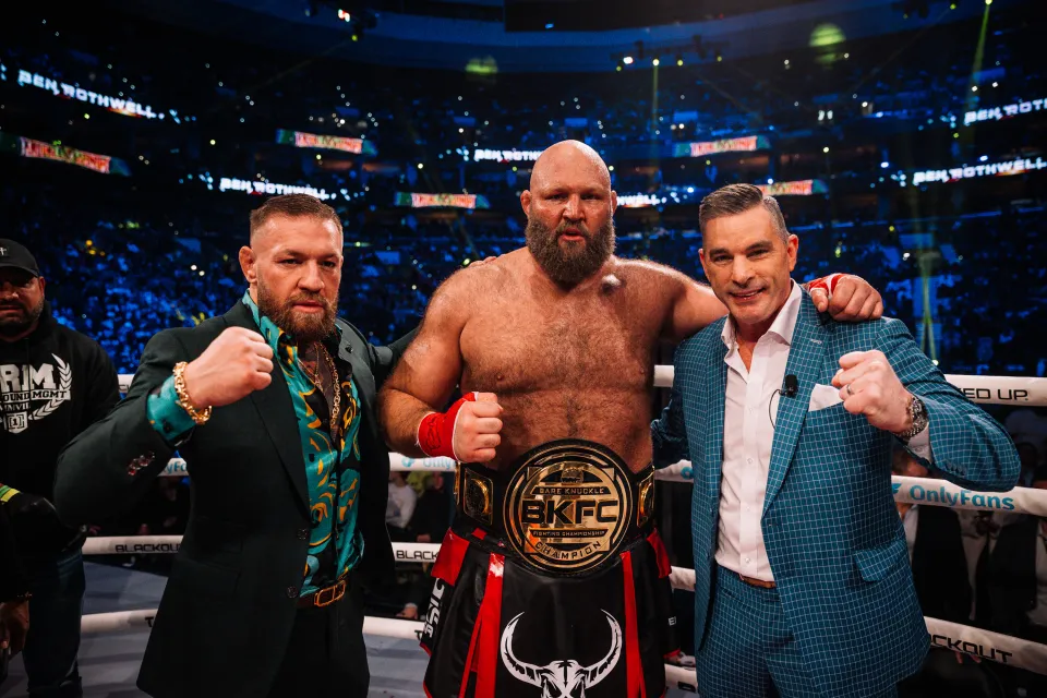 Conor McGregor poses in the ring at a BKFC event