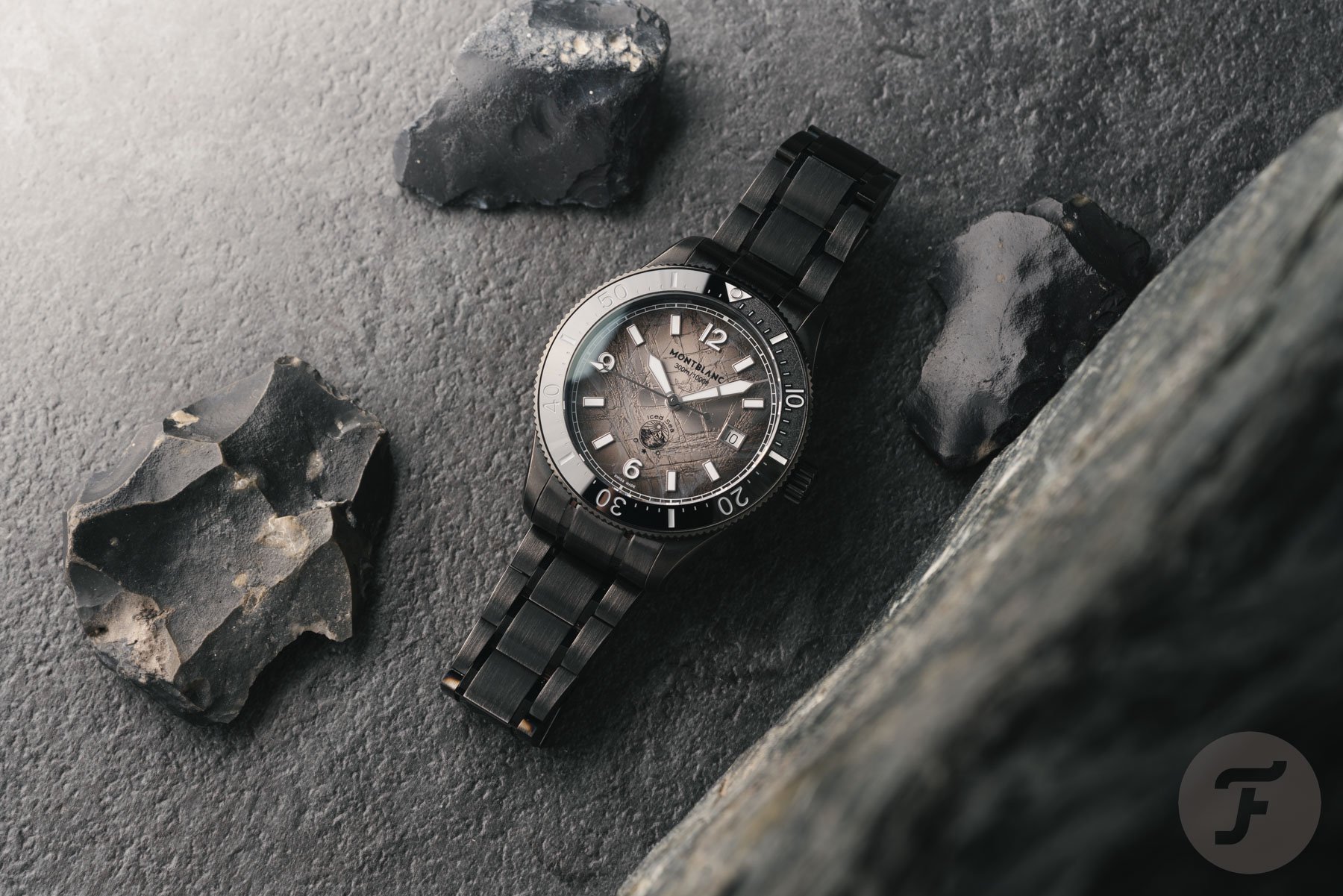 Montblanc Iced Sea Automatic Date 0 Oxygen ref. MB137541 flat-lay with rocks