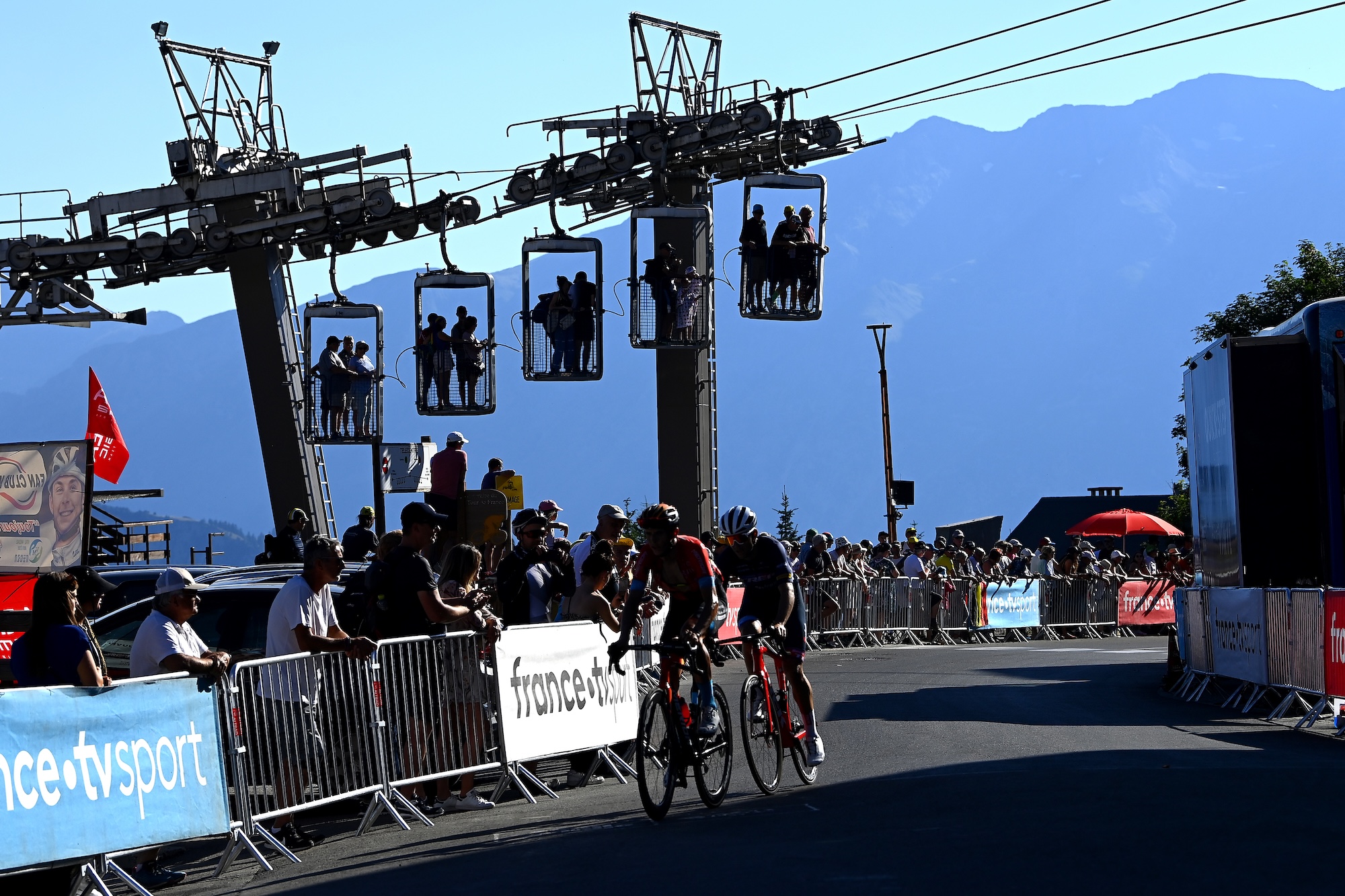 ALPE D'HUEZ, FRANCE - JULY 14: (L-R) Dylan Teuns of Belgium and Team Bahrain Victorious and Tony Gallopin of France and Team Trek - Segafredo cross the finish line during the 109th Tour de France 2022, Stage 12 a 165,1km stage from Brian&ccedil;on to L'Alpe d'Huez 1471m / #TDF2022 / #WorldTour / on July 14, 2022 in Alpe d'Huez, France. (Photo by Tim de Waele/Getty Images)
