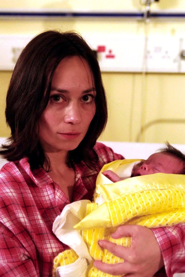 Zoe Tate holding her baby, Jean in a hospital