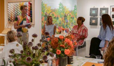 a panel of designers sat in front of a colorful backdrop
