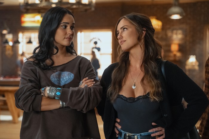 RANSOM CANYON SEASON 2 Two young women looking at each other, one has her arms folded, the other has her hands on her hips.