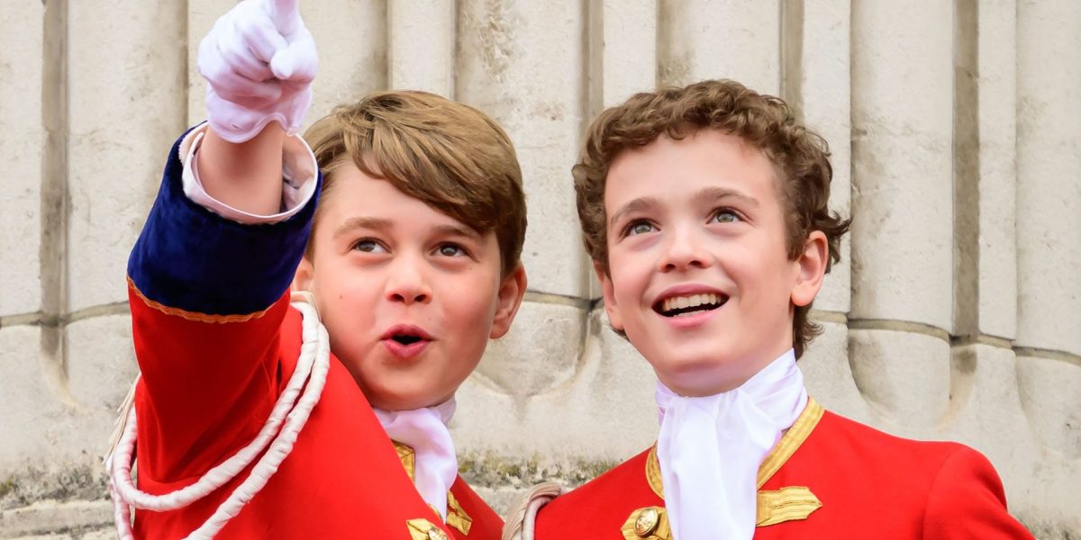 CORRECTION / TOPSHOT - Britain's Prince George of Wales (L) points next to another page, as they stand on the Buckingham Palace in London, following the coronations of King Charles III and Queen Camilla, on May 6, 2023. - The set-piece coronation is the first in Britain in 70 years, and only the second in history to be televised. Charles will be the 40th reigning monarch to be crowned at the central London church since King William I in 1066. Outside the UK, he is also king of 14 other Commonwealth countries, including Australia, Canada and New Zealand. Camilla, his second wife, will be crowned queen alongside him, and be known as Queen Camilla after the ceremony. (Photo by Leon Neal / POOL / AFP) / "The erroneous mention[s] appearing in the metadata of this photo by Leon Neal has been modified in AFP systems in the following manner: [points next to another page] instead of [points next to Freddy Parker Bowles ]. Please immediately remove the erroneous mention[s] from all your online services and delete it (them) from your servers. If you have been authorized by AFP to distribute it (them) to third parties, please ensure that the same actions are carried out by them. Failure to promptly comply with these instructions will entail liability on your part for any continued or post notification usage. Therefore we thank you very much for all your attention and prompt action. We are sorry for the inconvenience this notification may cause and remain at your disposal for any further information you may require." (Photo by LEON NEAL/POOL/AFP via Getty Images)