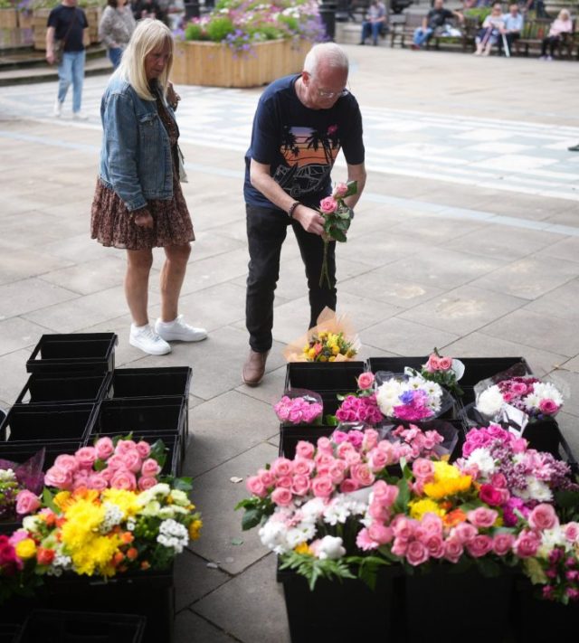 SOUTHPORT, ENGLAND - JULY 29: People begin to lay flowers outside the The Atkinson for the first anniversary of the Southport stabbings that left three girls dead on July 29, 2025 in Southport, England. 17-year-old Axel Rudakubana, armed with a knife, attacked children at a Taylor Swift-themed holiday club in Hart Lane, Southport, a year ago today. Elsie Dot Stancombe, 7, Bebe King, 6, and Alice da Silva Aguiar, 9, died, and nine children and two adults were treated in hospital for their wounds. Rudakubana was tried on 16 charges, including murder and attempted murder and sentenced to life imprisonment with a minimum term of 52 years. (Photo by Christopher Furlong/Getty Images)
