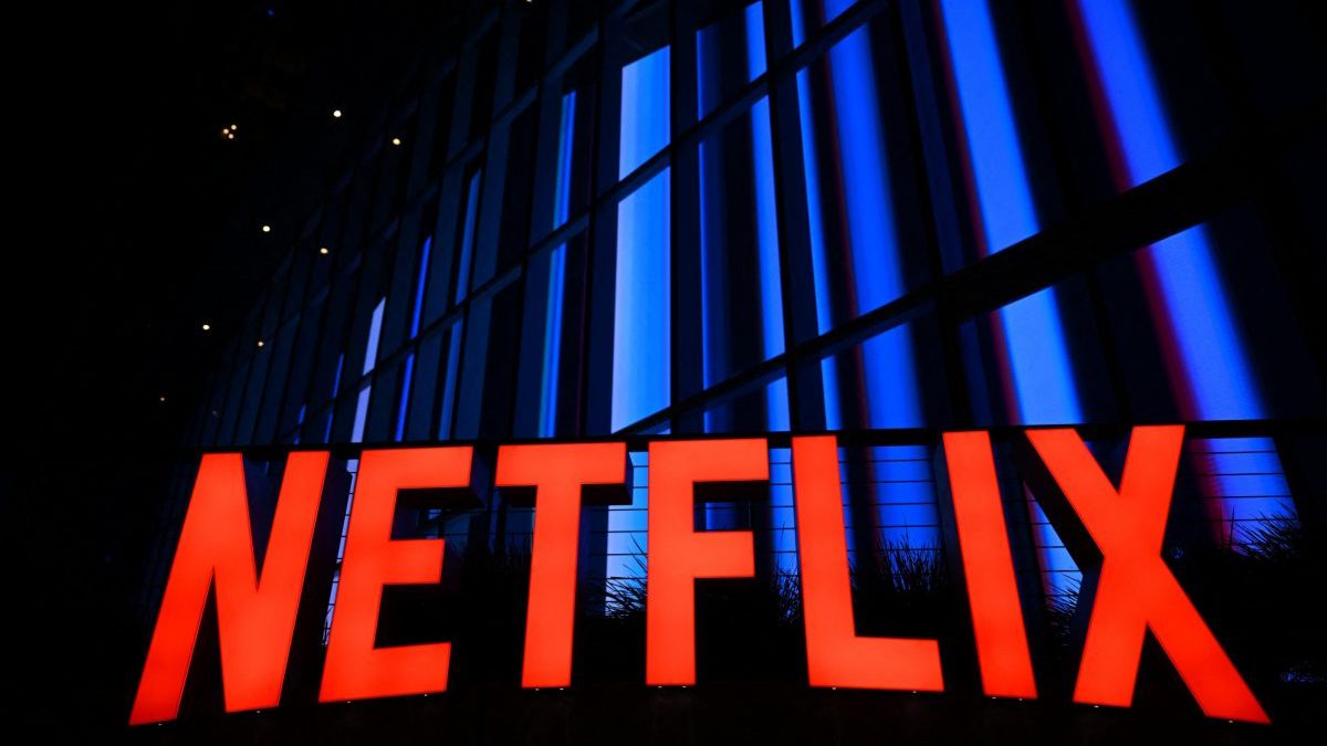 (FILES) The Netflix logo is seen at the Netflix Tudum Theater in Los Angeles, California, on September 14, 2022. Streaming giant Netflix will acquire film and television studio Warner Bros. Discovery for nearly $83 billion, the two US companies announced in a joint statement on December 5, 2025. (Photo by Patrick T. FALLON / AFP via Getty Images)