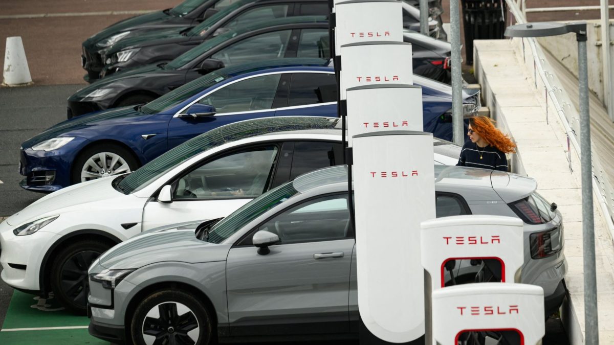 (FILES) People charge their electric cars at a Tesla electric charging station in Saint-Herblain, western France, on April 15, 2026, as US-Israel war on Iran, launched on February 28, has roiled global energy and equities markets, sending oil prices skyrocketing after Tehran virtually closed the key Strait of Hormuz. New electric car sales in France jumped 48 percent year-on-year in the first four months of the year to 148,302 units, even as the broader automotive market struggled, the automotive industry body PFA, which represents all carmakers, said on May 1, 2026. (Photo by Loic VENANCE / AFP via Getty Images)