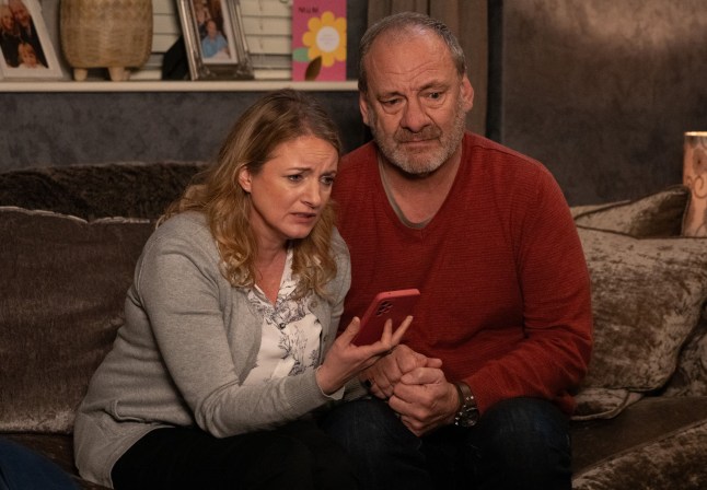 Nicola and Jimmy on the phone in their house in Emmerdale