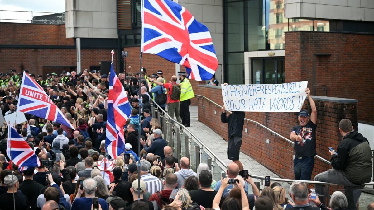 Demonstrators hold a banner reading 'Starmer = Responsibile. Your Hate Words!!' as they protest about the Police's handling of the detention of victim Henry Nowak, outside Southampton Central Police Station in Southampton, southern England, on June 2, 2026, following the conviction of his murderer Vickrum Digwa. Body camera footage of dying student Henry Nowak, who was handcuffed by British police after being stabbed by Sikh man Vickrum Digwa, and falsely accused of racially abusing his murderer sparked outrage Tuesday. (Photo by JUSTIN TALLIS / AFP via Getty Images)