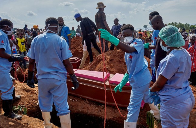 FILE PHOTO: Red Cross workers handle the coffin of a man who died of Ebola virus before his burial, as aid agencies intensify efforts to contain the Ebola outbreak caused by the Bundibugyo virus, at the Nyamurongo cemetery in Bunia town, Ituri province, Democratic Republic of Congo, June 10, 2026. REUTERS/Gradel Muyisa Mumbere/File Photo