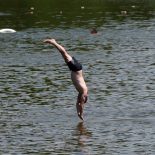 People swim in the lido at Hampstead Heath, London. A rare red warning for extreme heat has been issued by the Met Office as the UK has sweltered in exceptionally hot and humid conditions. The heatwave, driven by a 