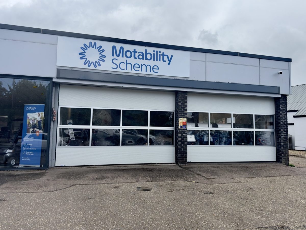 Diss, UK - September 4, 2925: A sign and logo for the Motability Scheme at the NBR Mobility showroom in Diss, Norfolk.