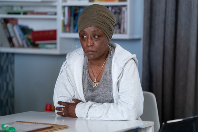 Denise sat at the kitchen table in EastEnders