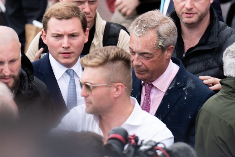 File photo dated 04/06/24 of Leader of Reform UK Nigel Farage with George Cottrell (left) , as Mr Farage has a milkshake thrown over him leaving the Moon and Starfish pub after launching his General Election campaign in Clacton-on-Sea, Essex. Farage needs to 