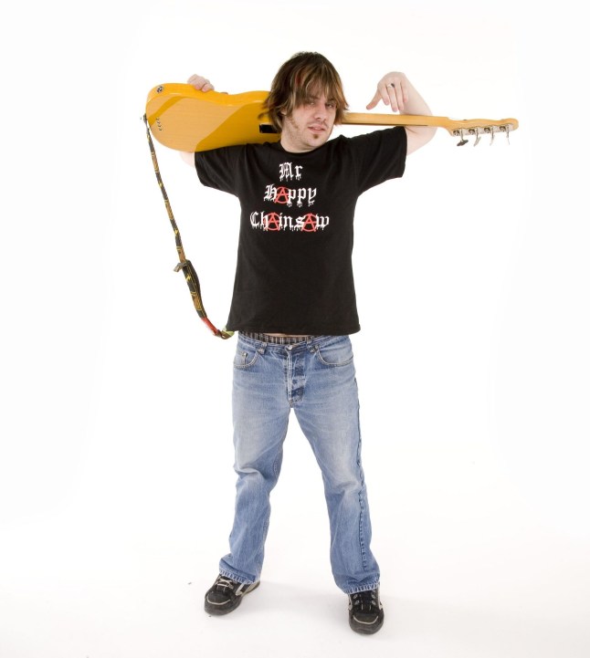 Joe Murphy of Koopa band holding a guitar