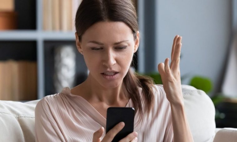 A woman looks at her phone