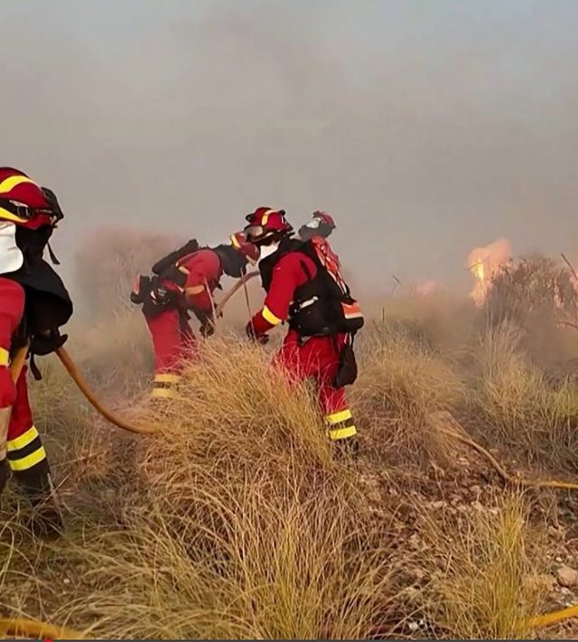 TOPSHOT - This handout photo released by the Military Emergency Unit (UME) on July 10, 2026 shows firefighters working on a wildfire that killed 11 near Bedar, in Los Gallardos district, in Almeria Province, on July 10, 2026. Eleven people were killed and 19 are missing after a wildfire tore through a Spanish village, with four victims who may have been British who were burned in their car, authorities said. (Photo by Handout / UME / AFP via Getty Images) / RESTRICTED TO EDITORIAL USE - MANDATORY CREDIT 