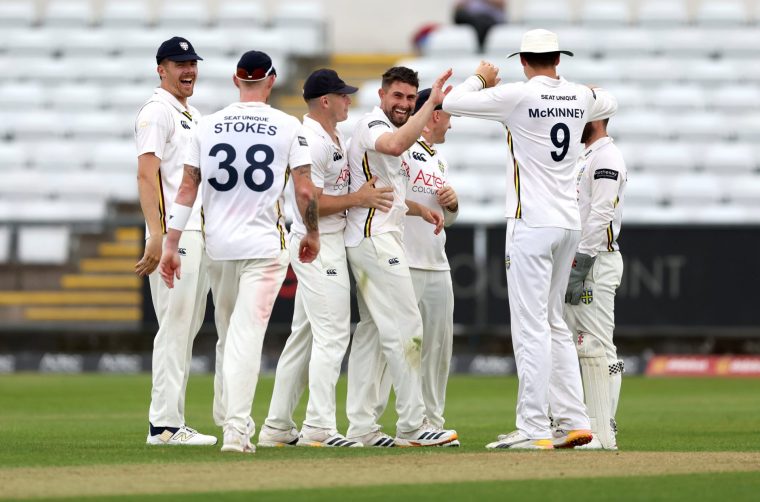 CHESTER-LE-STREET, ENGLAND - JUNE 19: Will Rhodes of Durham celebrates with teammates after taking the wicket of Nathan McSweeney of Northamptonshire during the Rothesay County Championship Division 2 match between Durham and Northamptonshire at Banks Homes Riverside on June 19, 2026 in Chester-le-Street, England. (Photo by George Wood/Getty Images)