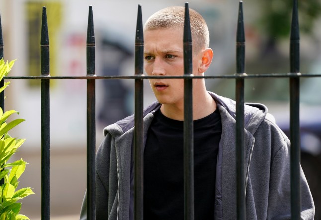 Joel stood in Walford in EastEnders