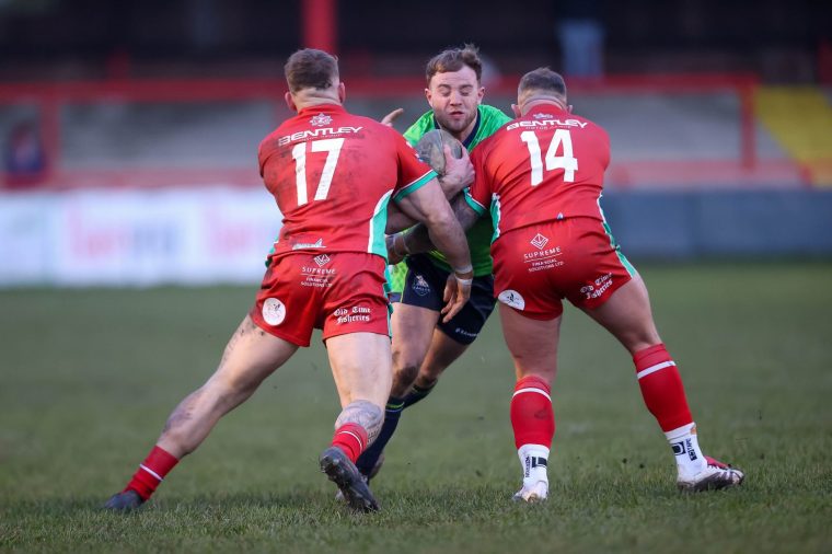 Blake Broadbent of Sheffield is tackled by Keighley defenders during the pre-season friendly match between Keighley Cougars and Sheffield Eagles at Cougar Park in Keighley, England, on December 20, 2025. (Photo by Simon Hall/MI News/NurPhoto via Getty Images)