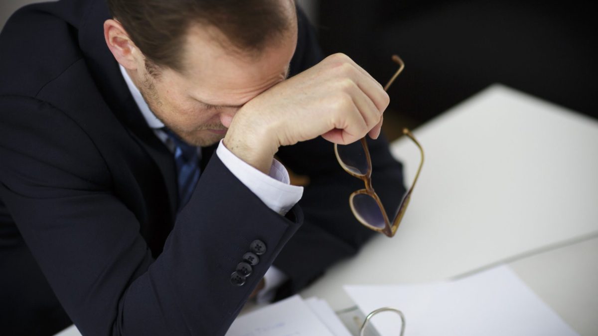 Berlin, Germany - March 23: In this Photo Illustration about workload a man sitting at a desk exhausted on March 23, 2016 in Berlin, Germany. (Photo Illustration by Thomas Trutschel/Photothek via Getty Images)