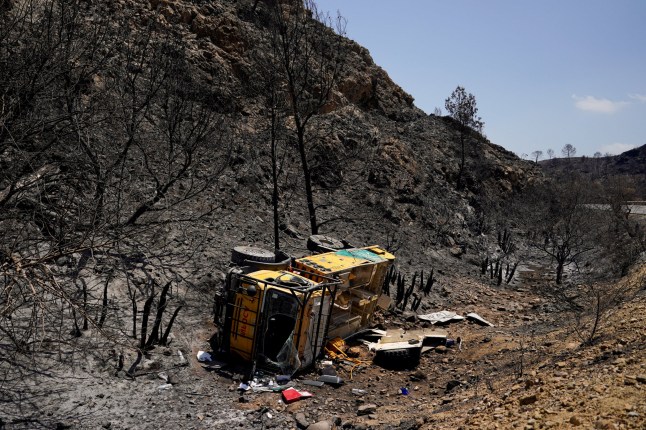 An emergency fire truck is overturned at the aftermath of deadly wildfires in Bedar, Almeria, Spain July 13, 2026.