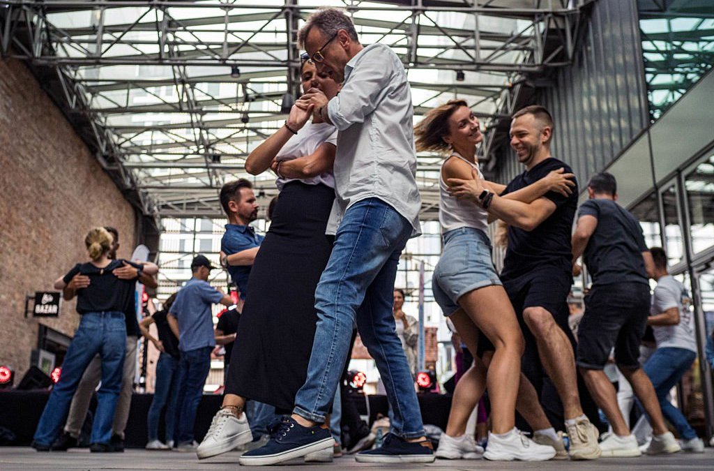 WARSAW, MAZOVIA, POLAND - 2025/07/13: Dancers enjoy the free Latin dance party. Norblin Factory Foundation and Dance Studio Salsa Libre invite Varsovian visitors to a unique series of dance meetings. Led by Maja Borkowska and Lukasz Marynowski, the program includes free Salsa and Bachata lessons then an open-air Latin dance party. (Photo by Neil Milton/SOPA Images/LightRocket via Getty Images)